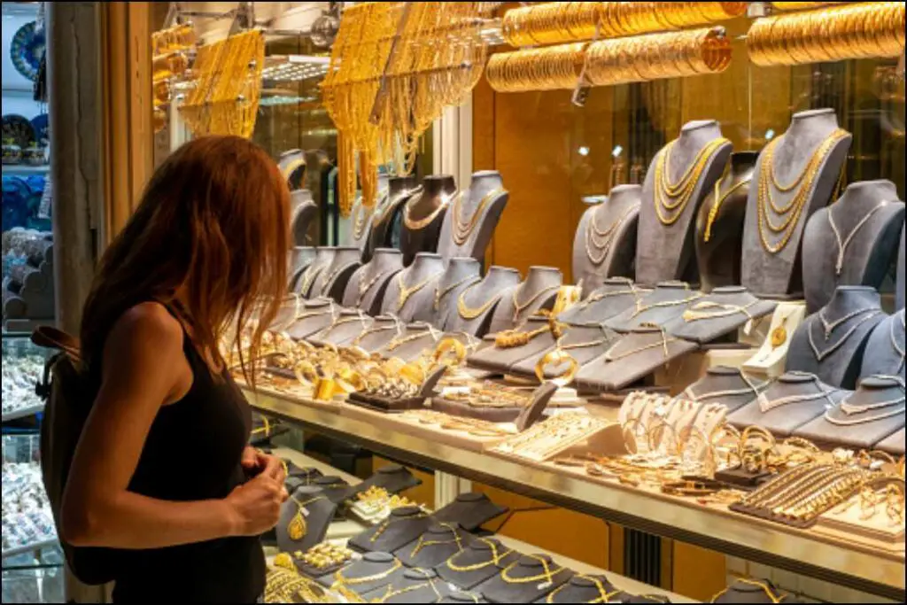woman looking at jewelery showcase, front view